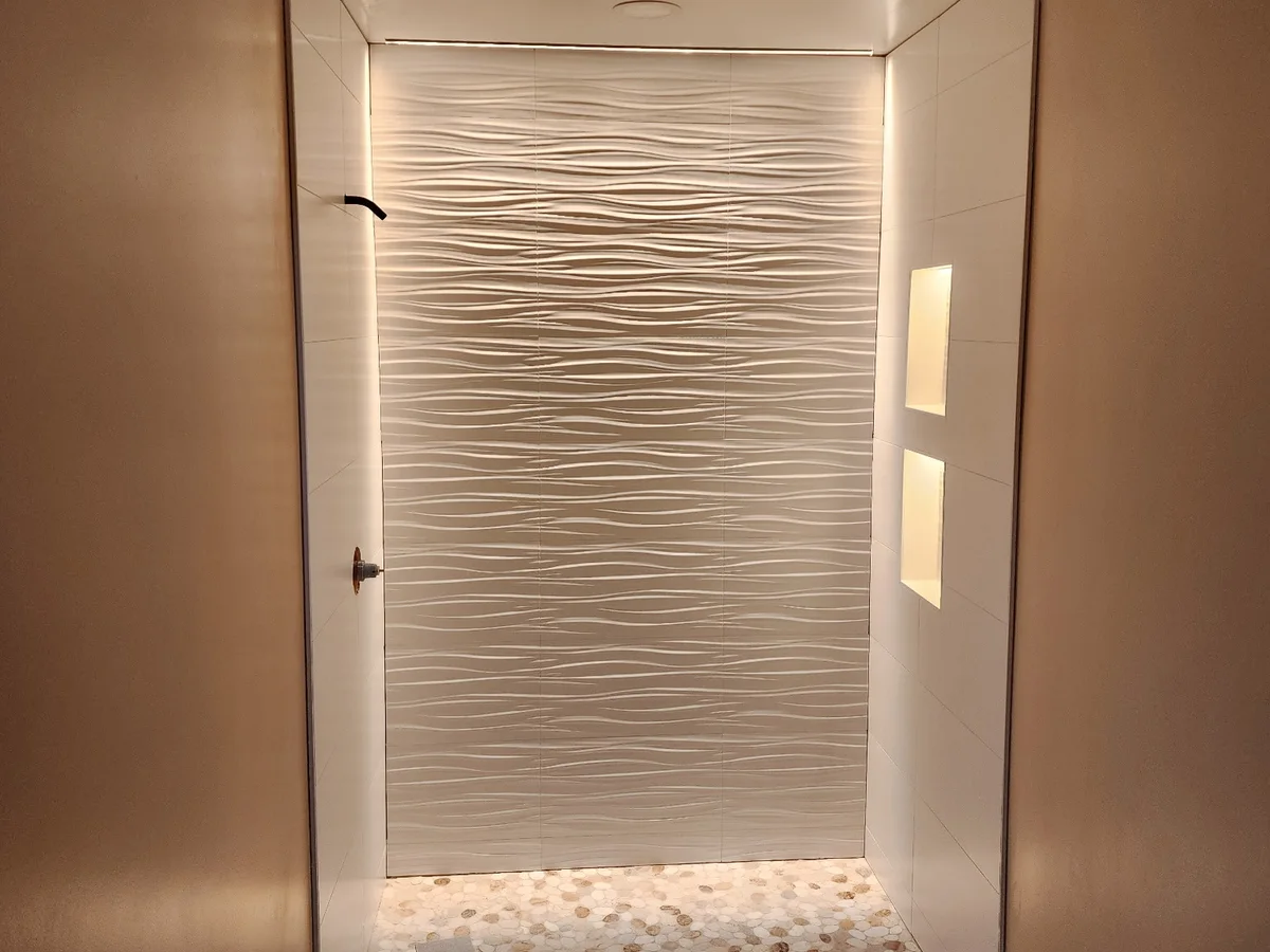 Finished tile shower with pebble floor and clean bathroom remodel details from a Kimmel project photo